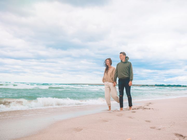 Couple walking down beach