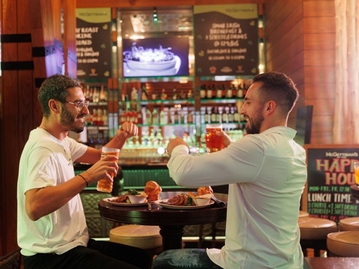McGettigan's JBR shot, with two men sitting at table with food
