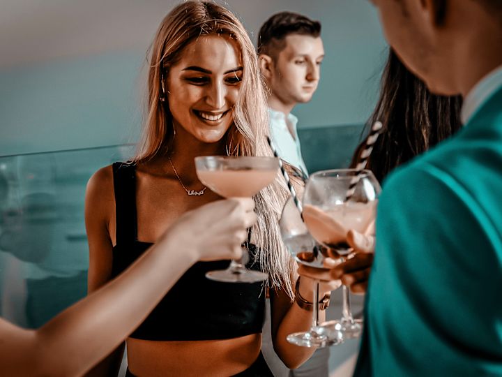 Pure Sky Lounge with group of friends raising glasses