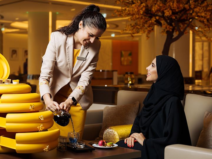 Woman being served by staff member in Social Bee