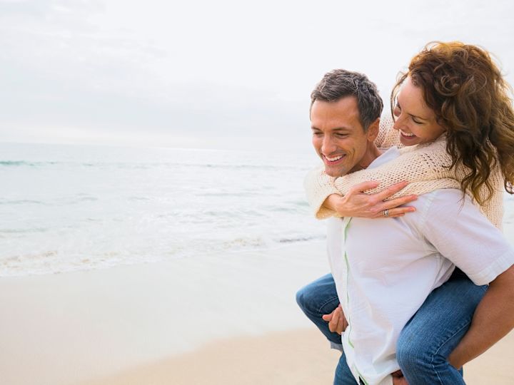 Lifestyle shot of couple hugging each other on beach