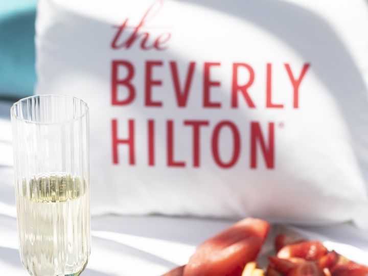 Beverly Hilton Sign and plate of food with champagne