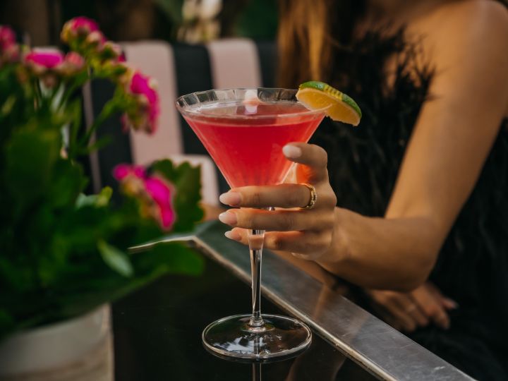 Woman with hand on cocktail