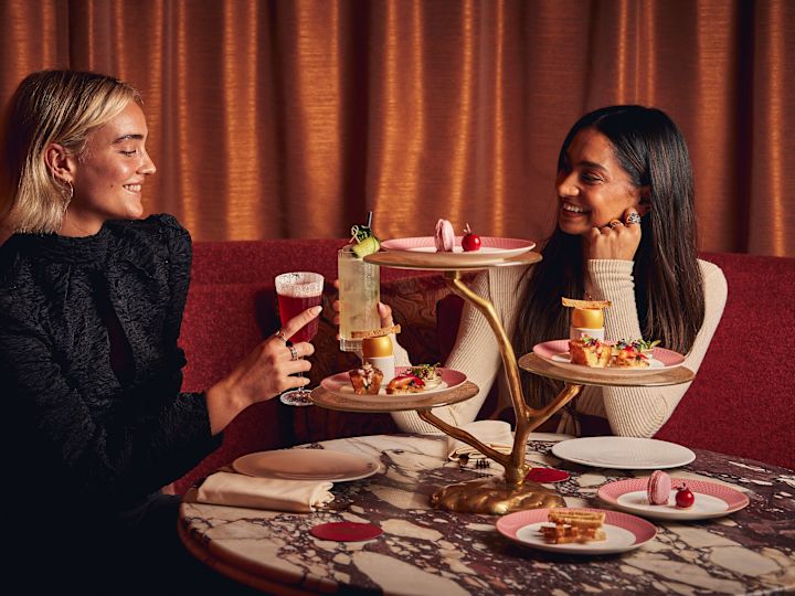 Two women enjoying tea, cakes & cocktails