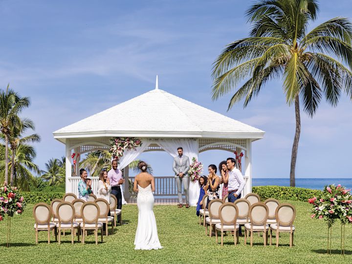 All-inclusive resort in Jamaica Happy just-married couple exiting ceremony at Hilton Rose Hall Resort & Spa