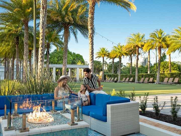 family sitting at outdoor firepit