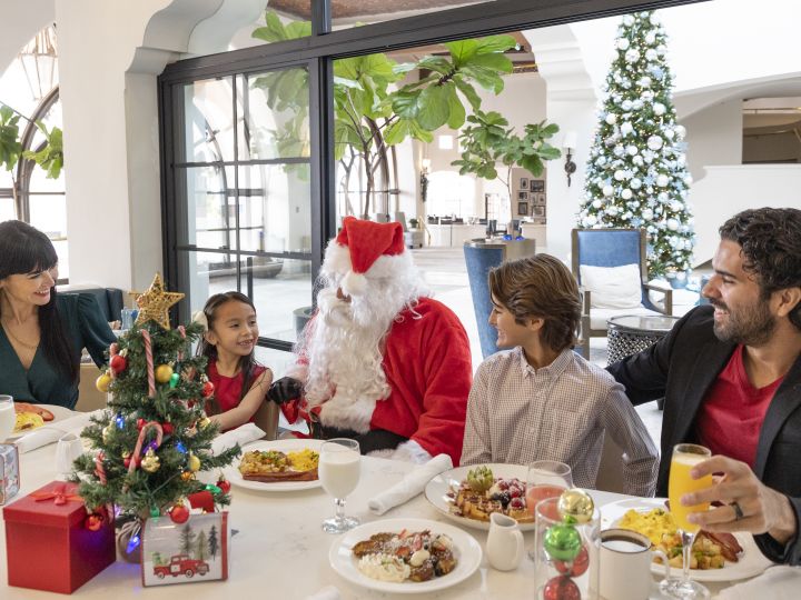 family eating at table with Santa