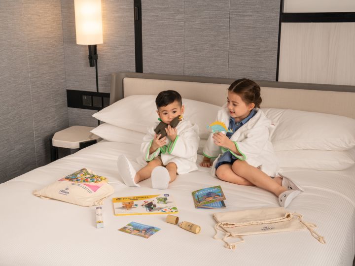 Kids on bed with toys