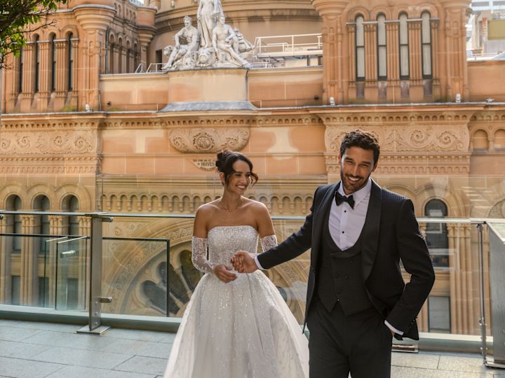 Shot of wedding couple in front of large domed building