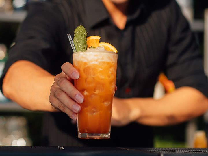 Bartender Holding a Cocktail at ThreeSixty Rooftop Bar