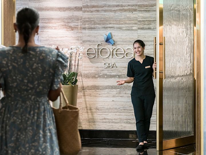 Team Member Welcoming Guests to Eforea Spa