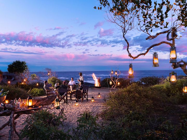 Couple Having Dinner on the Beach at Night
