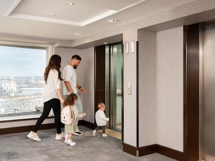 Family Walking into an Elevator at the Hotel