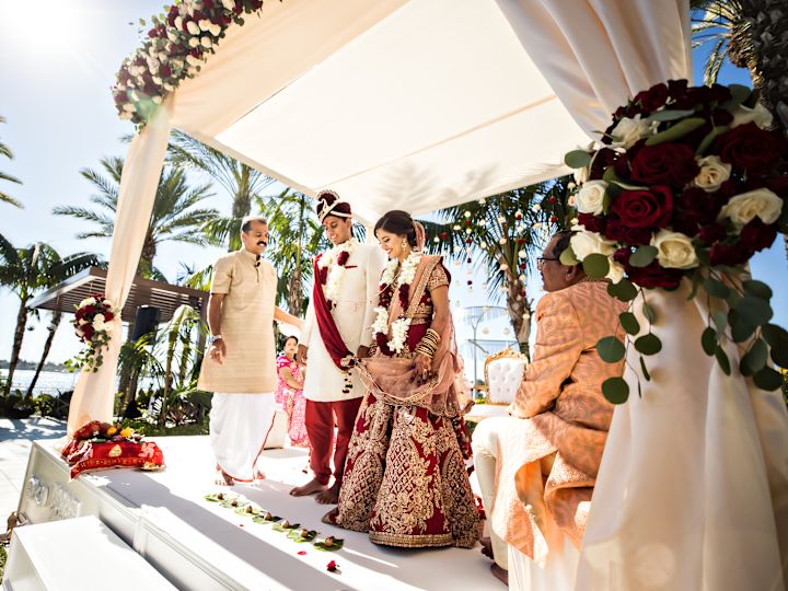 Wedding ceremony featuring bridge and groom participating in outdoor ceremony