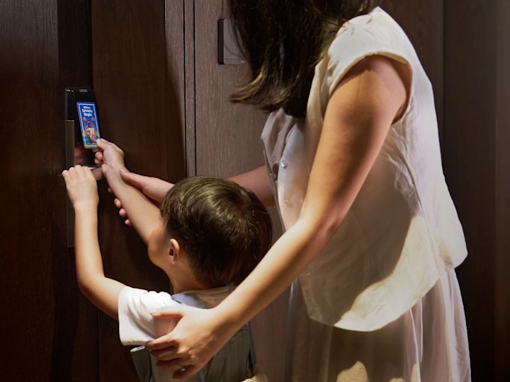 Boy and His Mother Opening a Guest Room Door with a Keycard