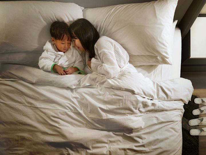 Mother and Son Sleeping in Bed