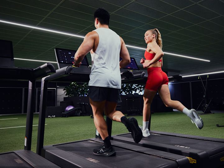 Couple Using Treadmills in Fitness Center