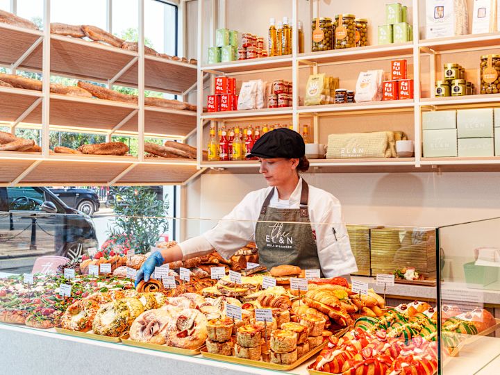 A Woman Serving Bakery Products at EL&N Food