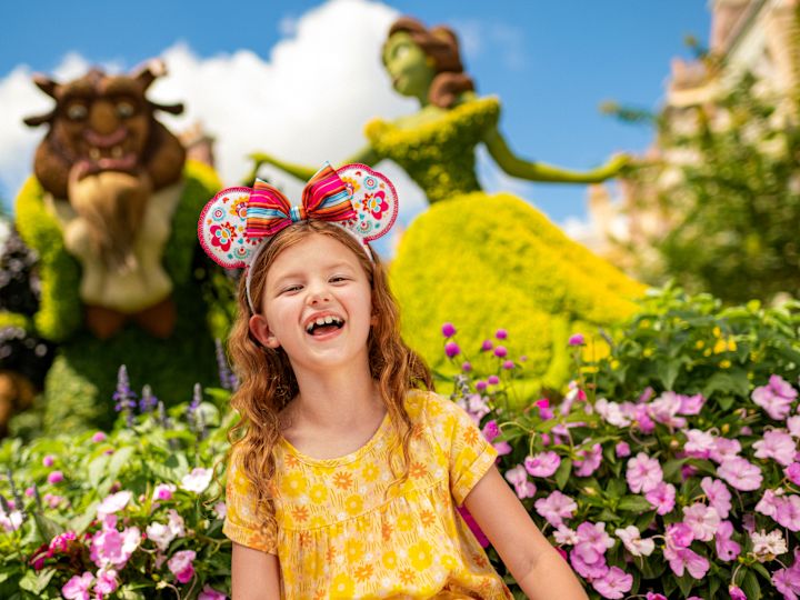 little girl in the garden with beauty and the beast