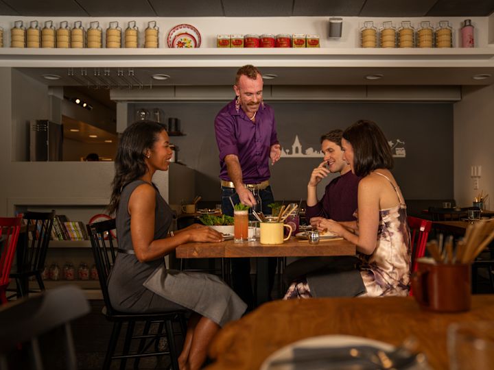 Server taking the order of a group of people at Kin Khao restaurant