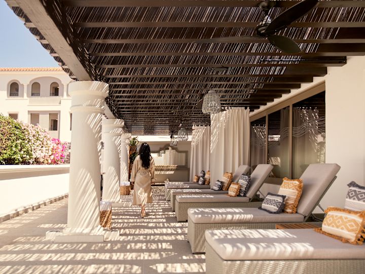 Woman Walking in Outdoor Spa Lounging Area
