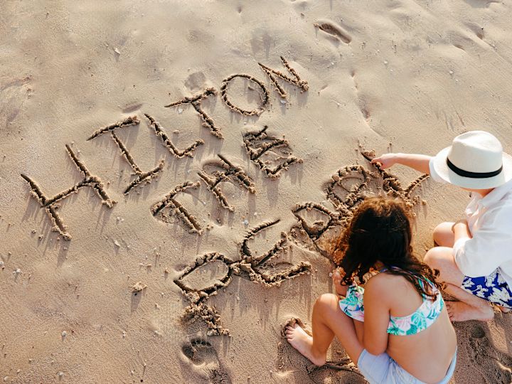 People writing in the sand