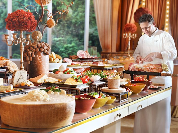 Chef in front of large food selection preparing food