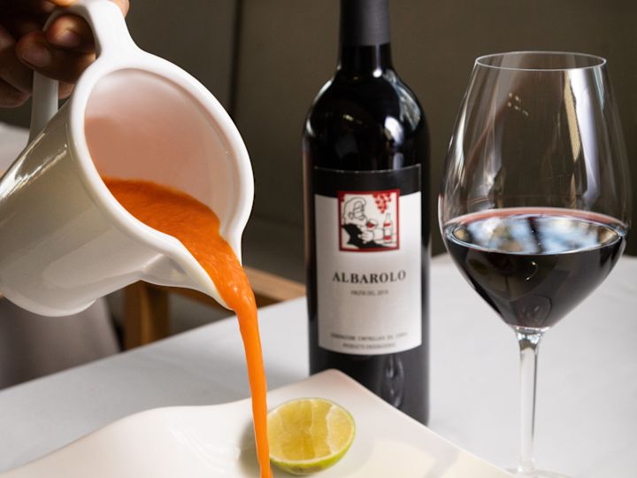 Dinner entree presentation with wine bottle and wine glass in the background