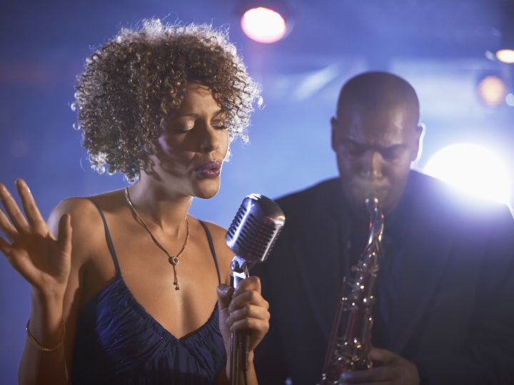 African American singer and saxophonist performing jazz music.