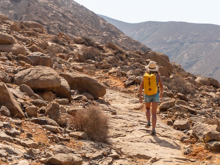 Donna con zaino nel deserto