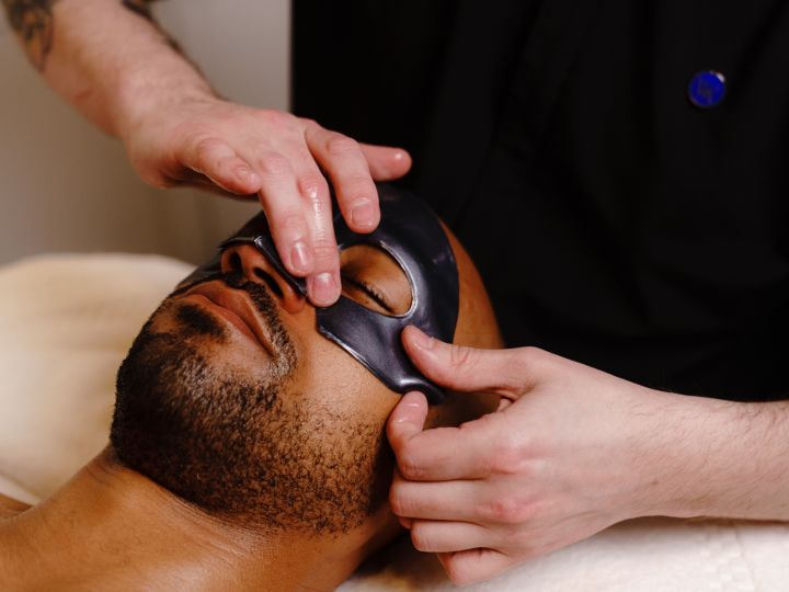 a man getting a facial at the spa