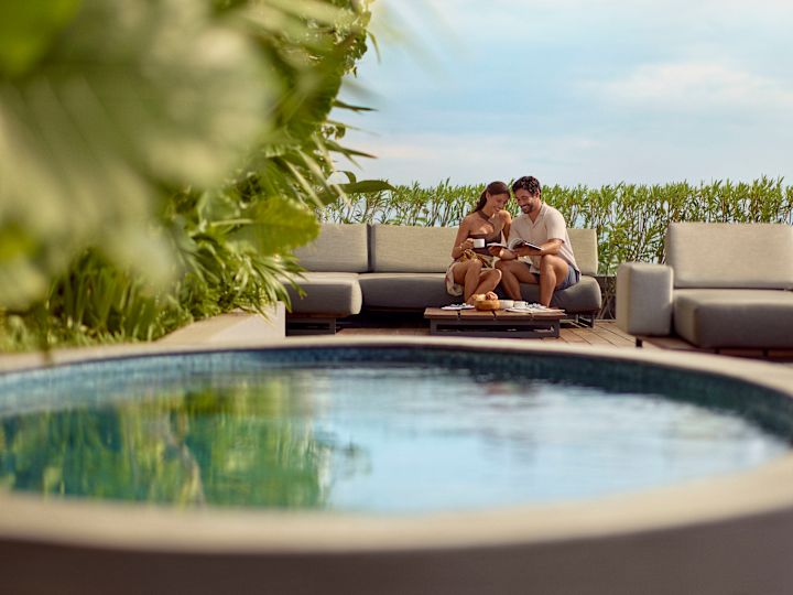 Couple sitting by round pool