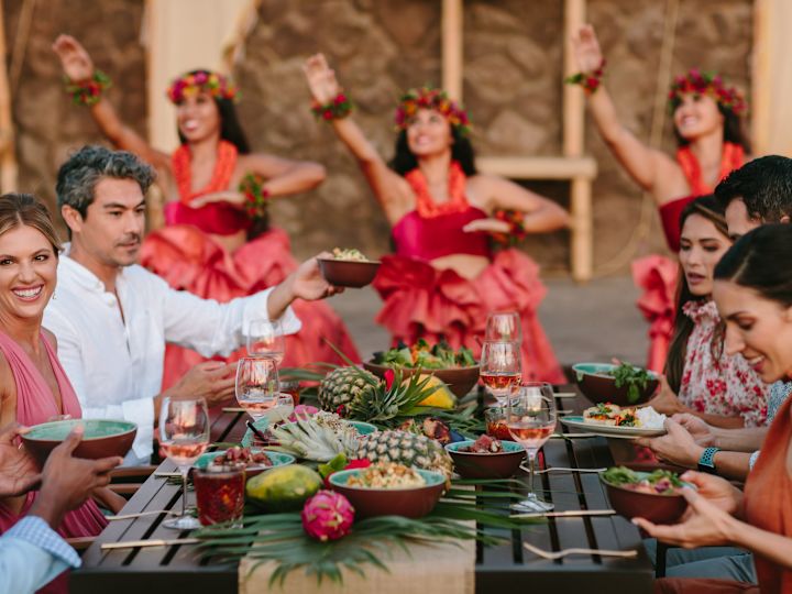 a Group of People Having Dinner at Luau Restaurant