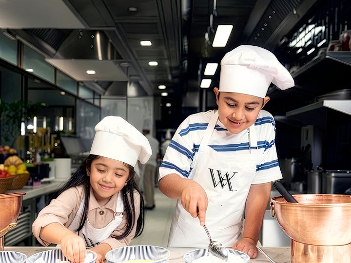 Kids making food with chef hats on