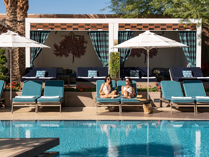 Women Enjoying Drinks and Relaxing in Outdoor Pool Area