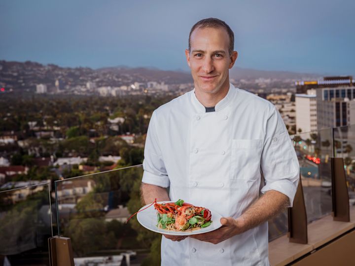 El chef Peleg prepara un plato de comida en la terraza del restaurante Gemma