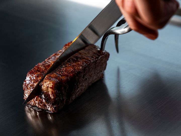 Chef Cutting Meat at TSUKIMI Restaurant