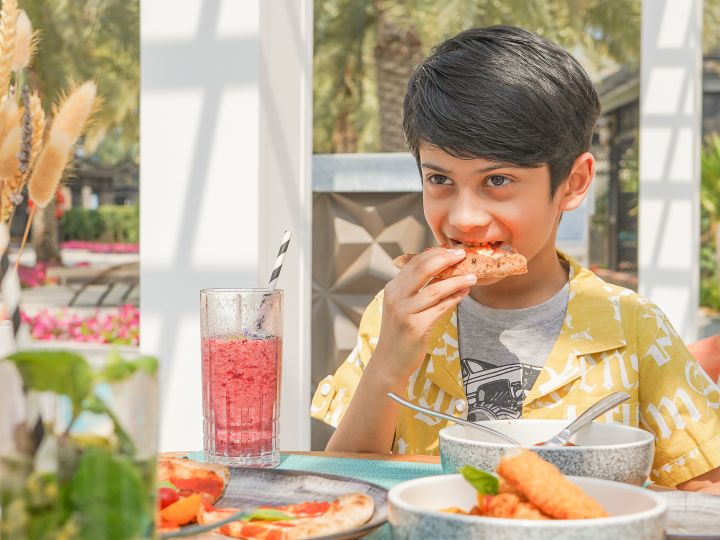 Kid eating children's dinner at Azure