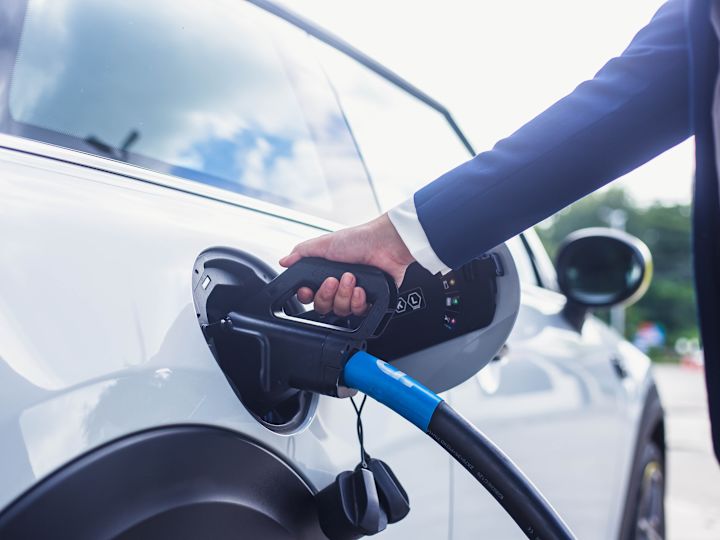 EV Charger shot of person putting charger in car