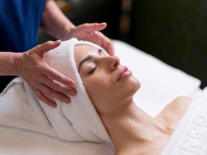 Woman receiving head massage