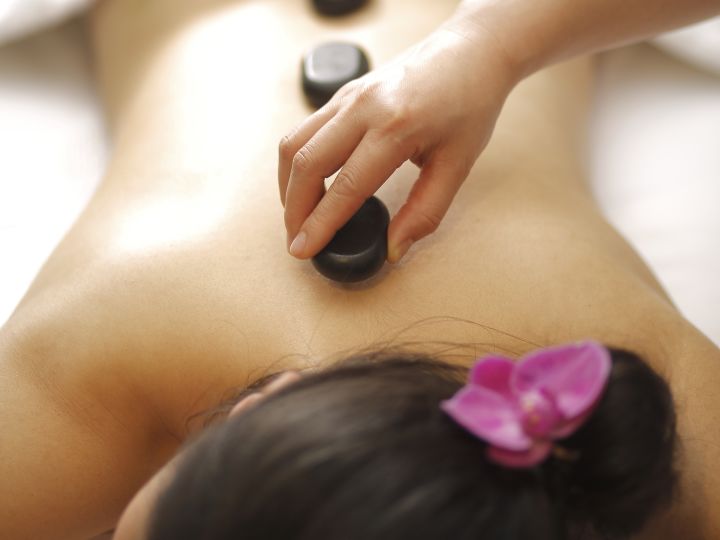 guest receiving a hot stone massage
