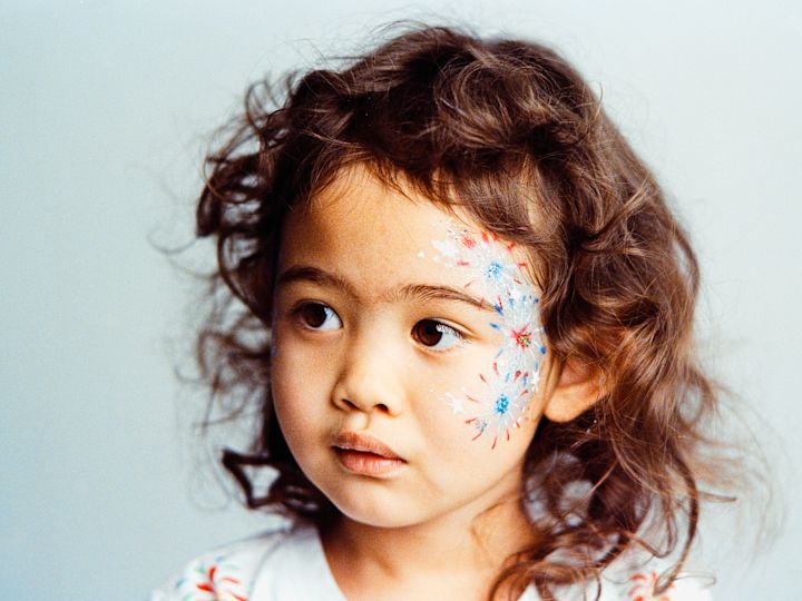 A Child with Facepainting 4th of July Experience
