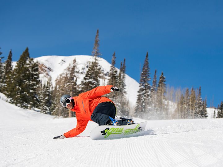 Person Snowboarding Down a Slope