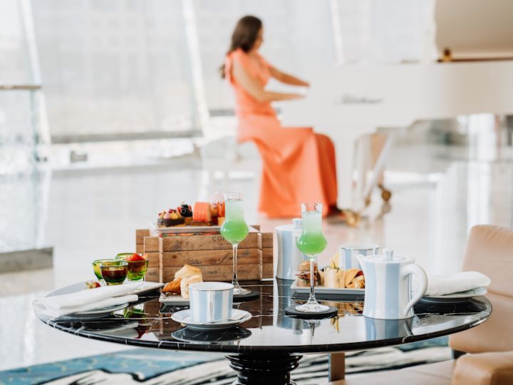 Observation Deck at 300, dinner table, girl playing the piano