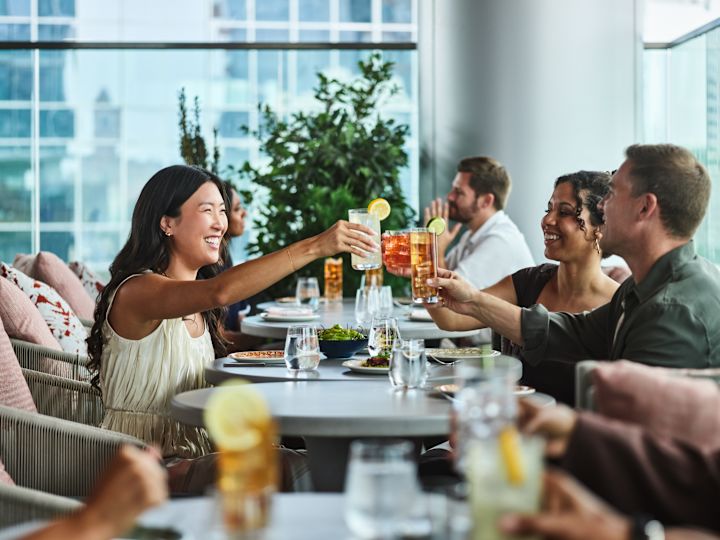 Thistle and Rye restaurant dining room, guests toasting