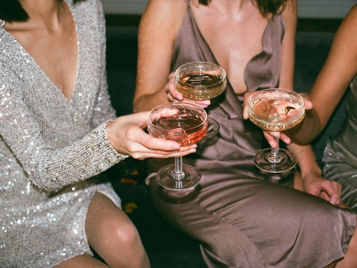 3 women holding champagne glasses together