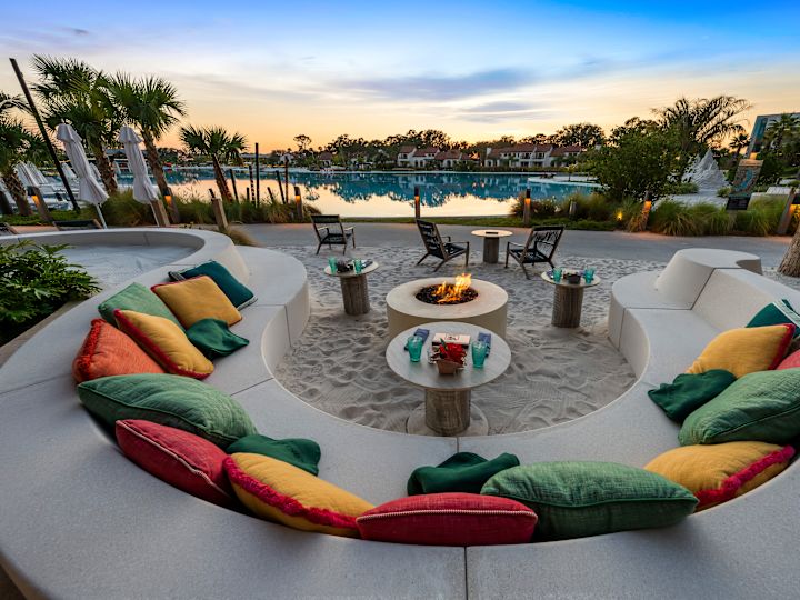 beach seating with decorative pillows, fire pit