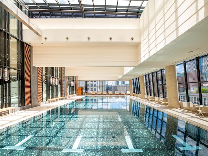 Indoor Pool with Large Windows and Siting Area