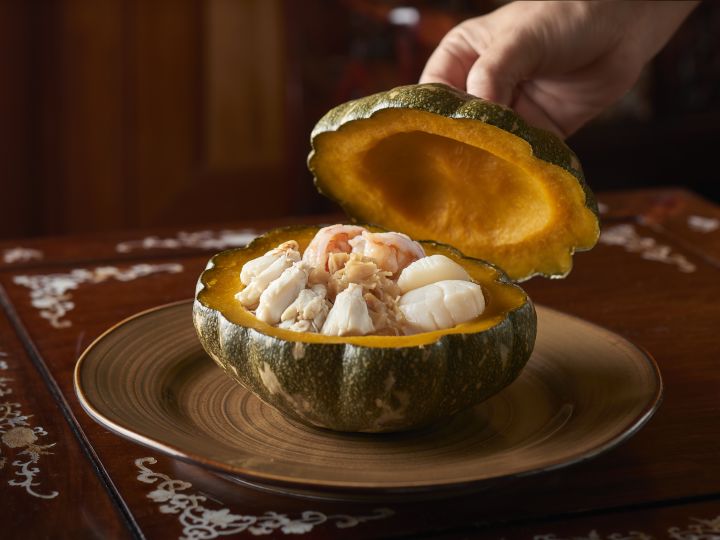 Crab meat and scallops inside a carved out melon