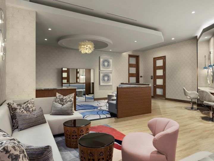 Apartament cu grupuri de cabane și scaune, plus un ghișeu cu oglinzi luminate deasupra